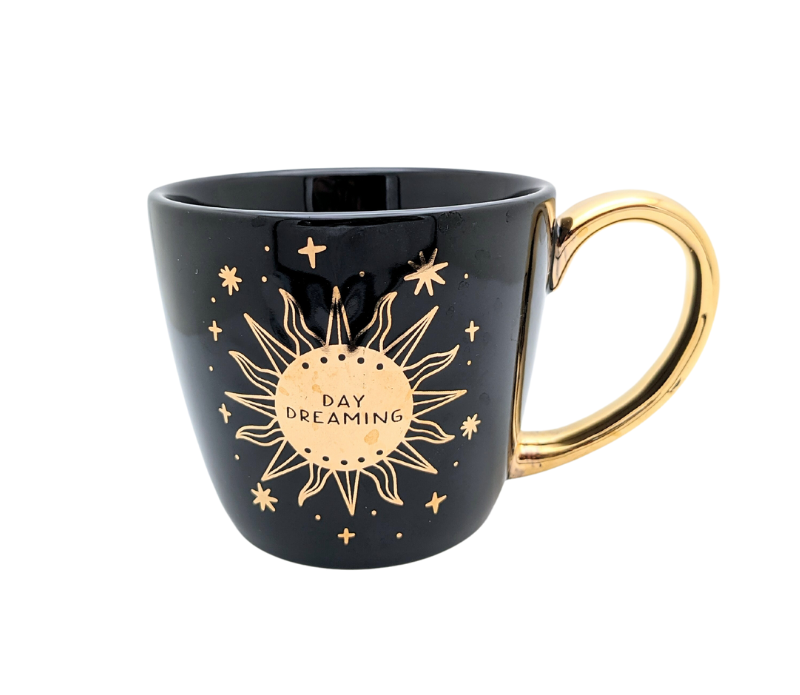 Black and celestial ceramic mug with moon and sun design available at Goddess Provisions